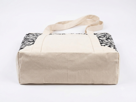 Black & White Geometric Printed tapestry and canvas women tote bag with a cream-coloured canvas base.